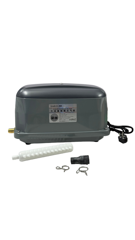 Gray electronic device with accessories on a white surface